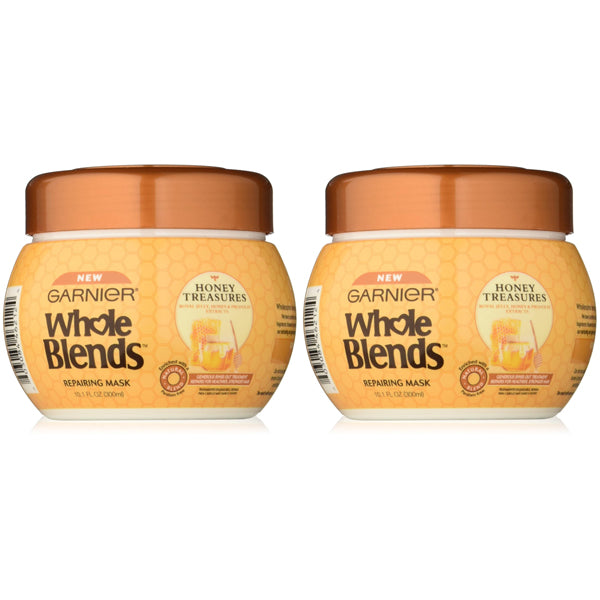 Two Garnier Whole Blends Repairing Honey Extracts Mask 10.1oz containers (2 Pack) are displayed side by side against a white background, highlighting their nourishing formula for healthy-looking hair.